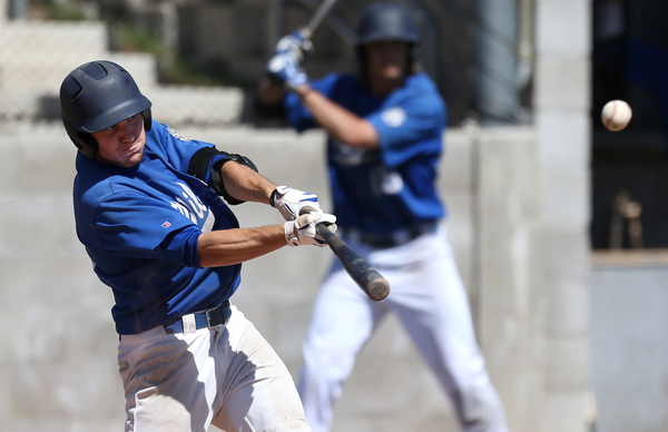 WNC's Bradley Lewis hits a one-run sacrifice fly Friday in Carson City. Photo by Cathleen Allison, Nevada Photo Source