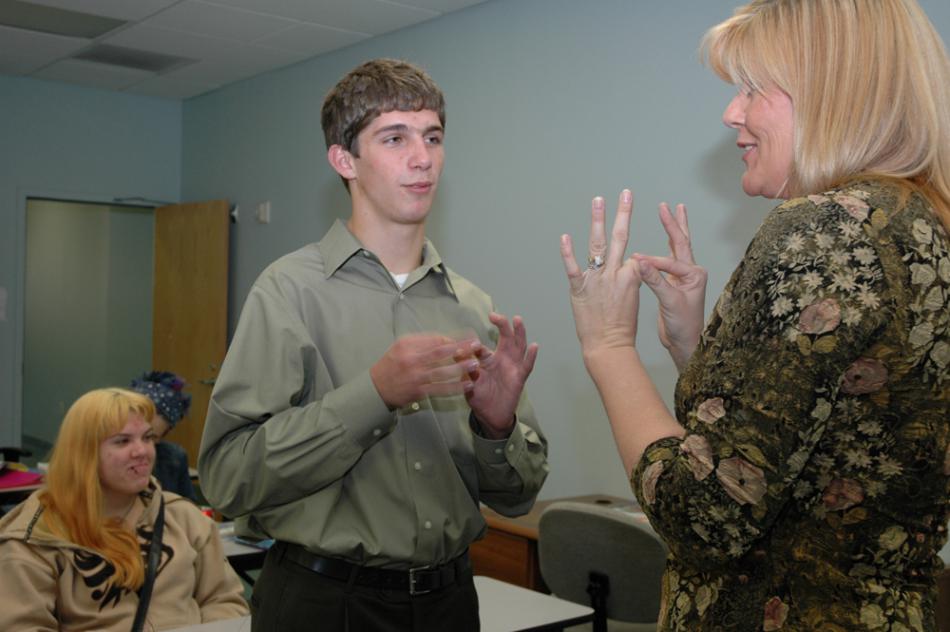 WNC Sign Language Instructor Cindy Frank signs with one of her students.