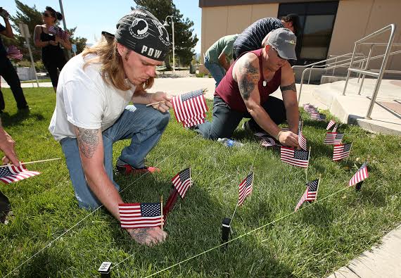 Timothy Dempsey, an Army veteran, helped plant flags Friday for Saturday's Veteran's walk.