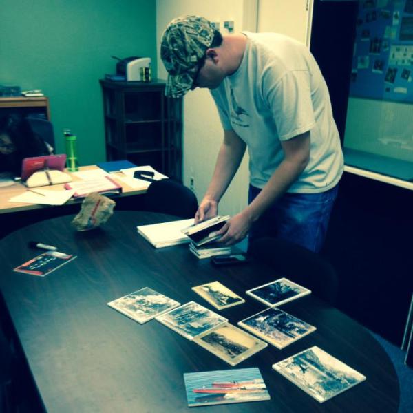 A UNR student puts together the Tahoe Recreation Experience: Fun at the Lake exhibit at the Shared History Lab.