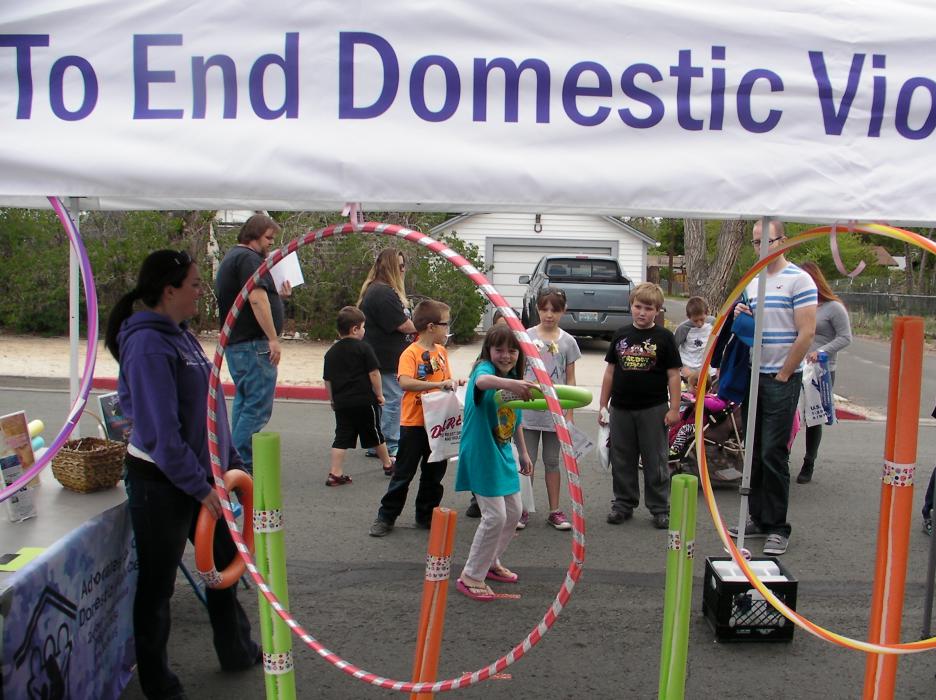 Ava Ponchzoch, 10, takes aim at a hoop throw hosted by Advocates to End Domestic Violence.