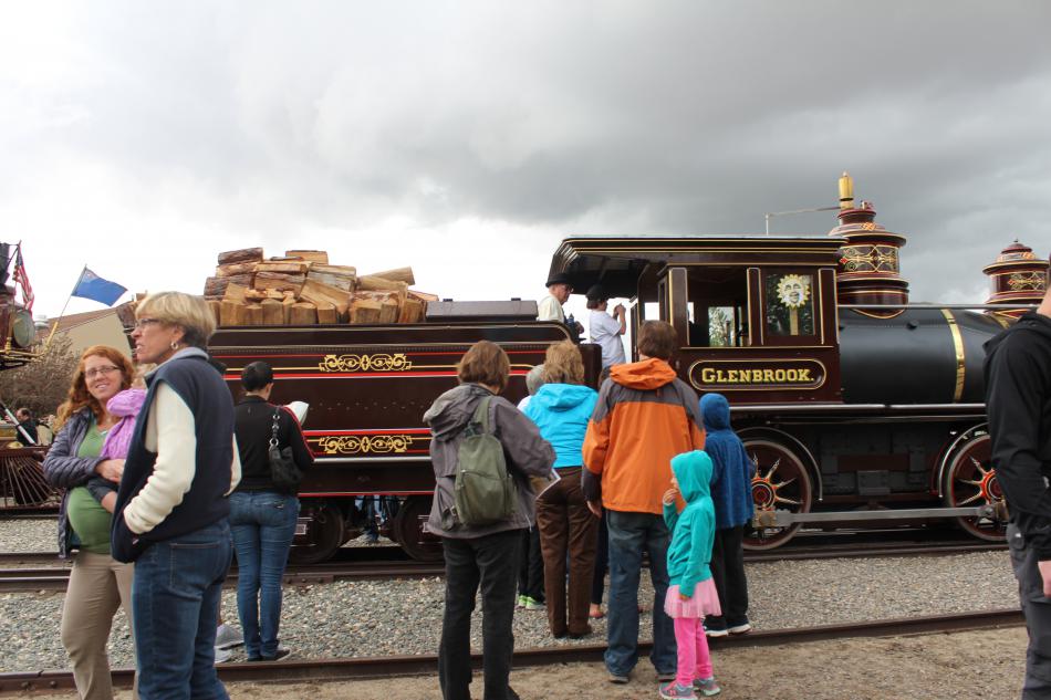 Guests line up to step inside the restored locomotive and to blow the train whistle.