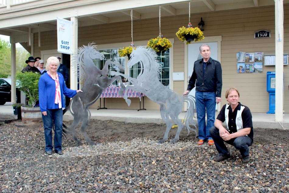 St. Clair (bottom right) poses with Chamber Chair Terrie McNutt, Carson City Mayor Bob Crowell with the mustang sculpture.