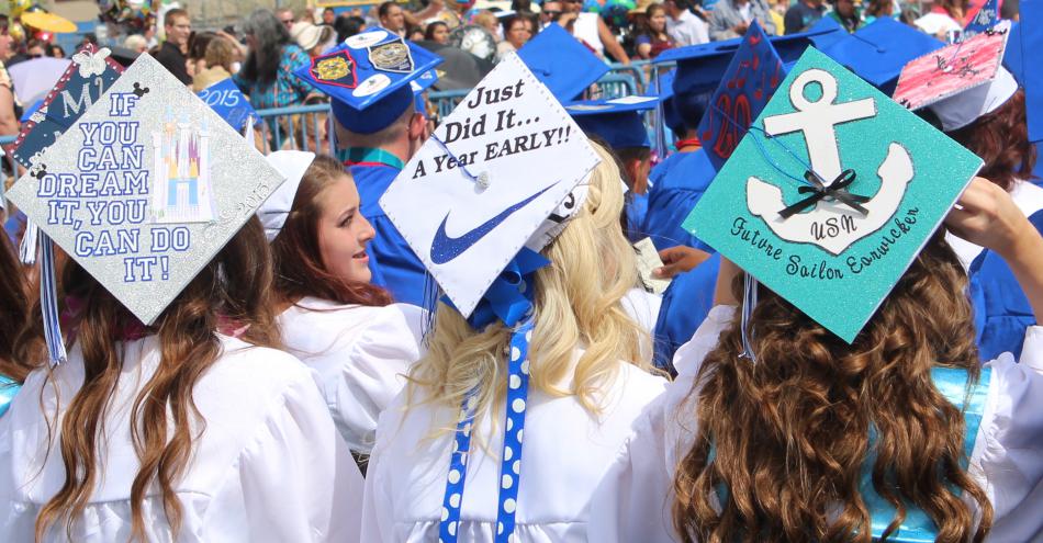 Graduates proudly wear their decorative caps.