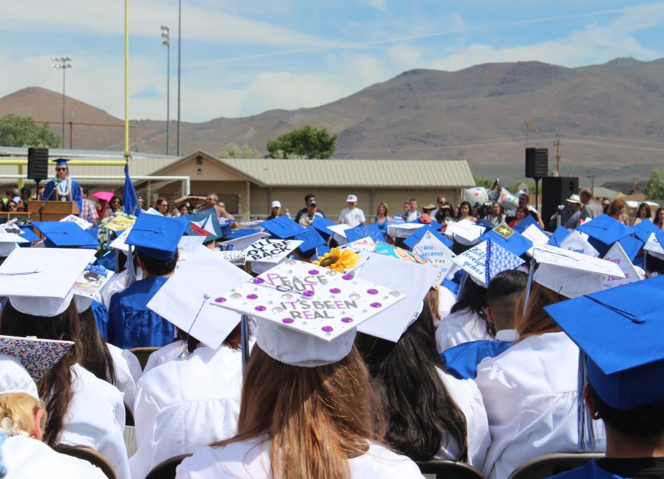 Graduates wait anxiously for their turn to walk the stage and receive their diplomas.