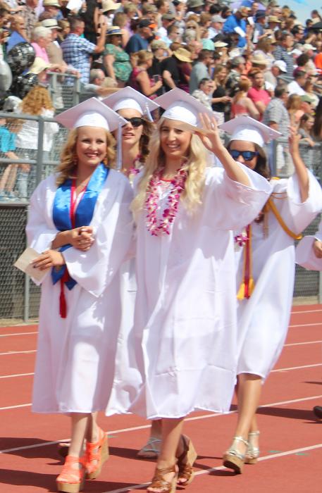 Hand in hand, graduates walk the Carson High track for perhaps the last time.