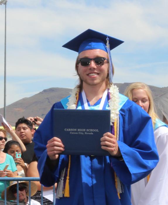 Student Body President, Hearn beams after finally receiving his diploma.