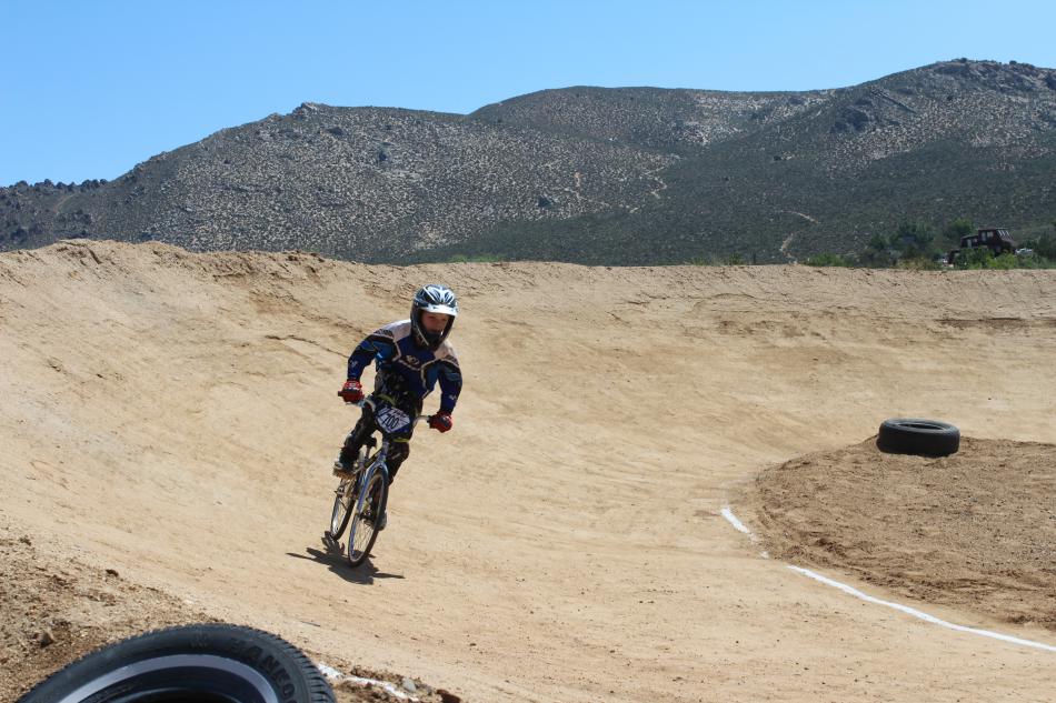 A rider leans into the last curve of the race.