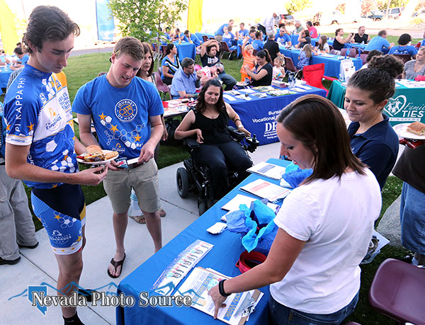 Cyclist Kyle Gacke, left, and Jarrod Wagner talk with Stephanie Rovetti and Nicole Whelchel, of the Downs Syndrome Network.