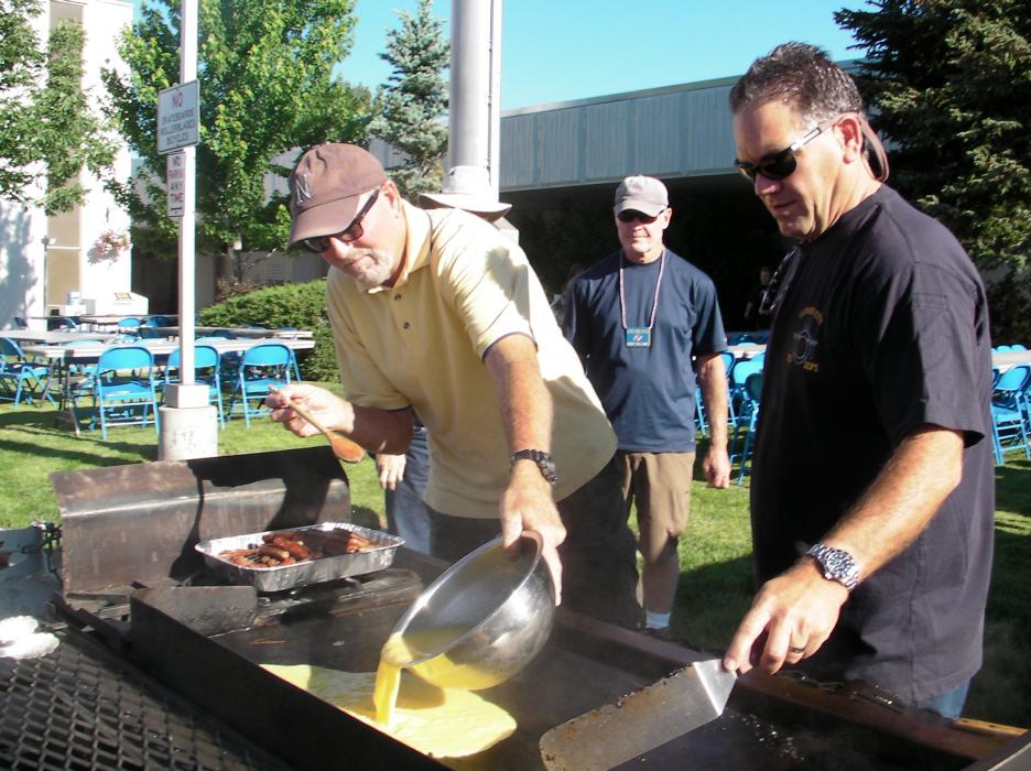 Greg Swift of Knights of Columbus and Carson City Fire Chief Bob Schreihans prepare scrambled eggs.