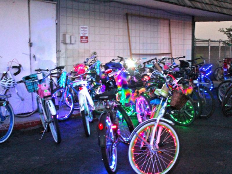 Bikes adorned with flashing lights parked outside The Feisty Goat.