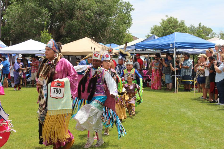 Young women learn dances and culture from their family members