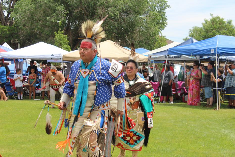 Beads from dancers rattle along with the drum beat