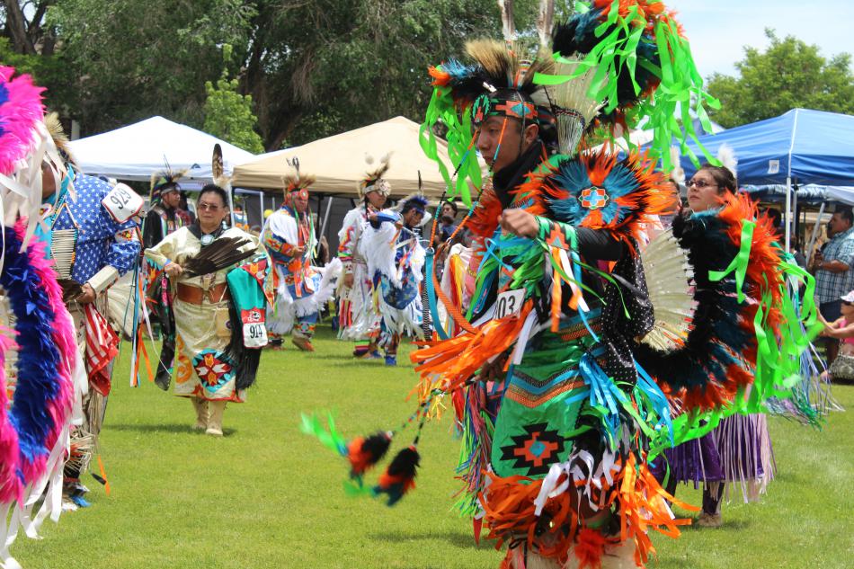 Brightly colored feathers dance through the crowd