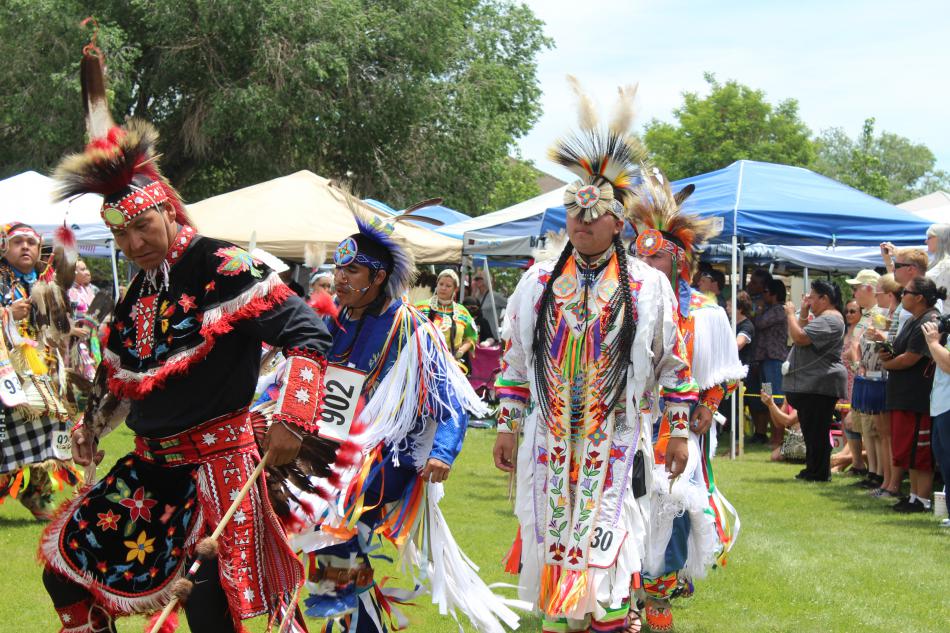 Men dance alongside each other