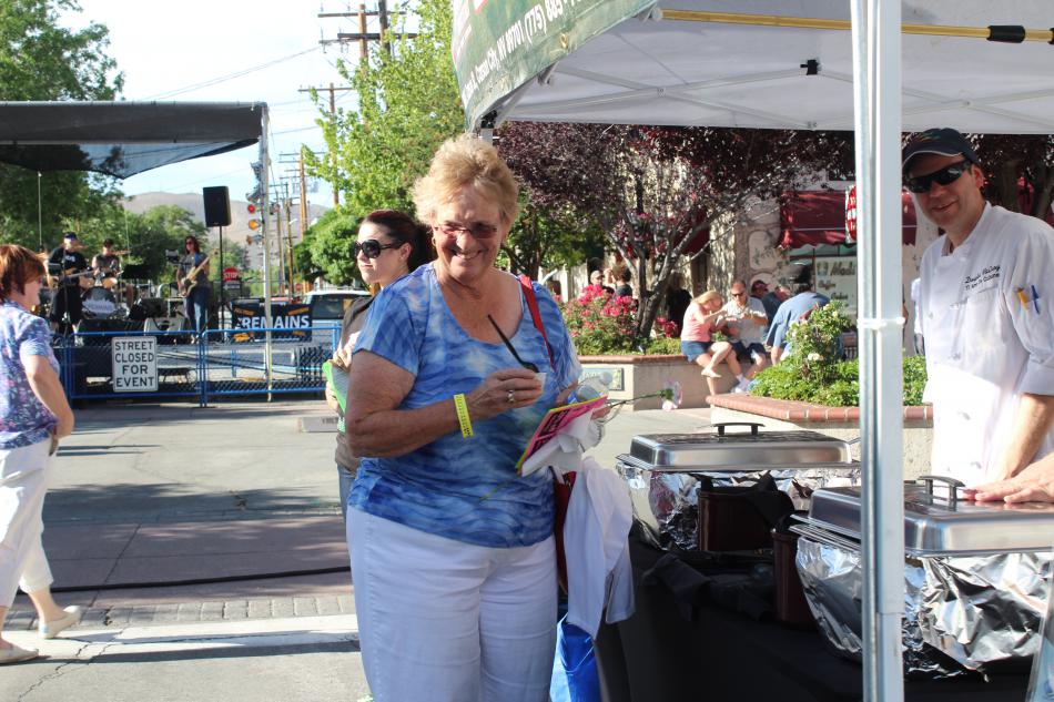 A woman leaves the Casino Fandango booth with a smile