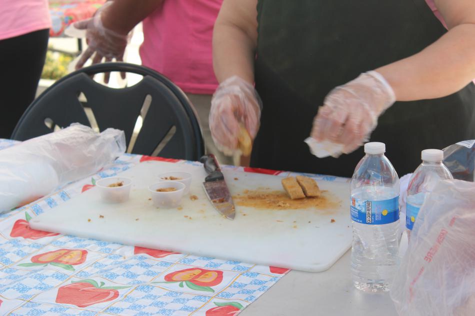 The Tamale Lady chops up tamales for her guests