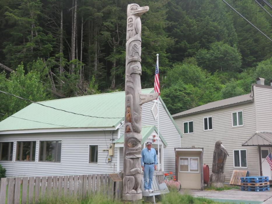 Six foot tall Don Quilici next to the Pelican totem pole. Photo by Elaine Quilici