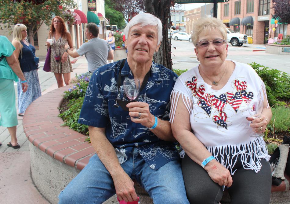 Nancie and Dave Pitts wear their white and blue while enjoying the red in their glasses.