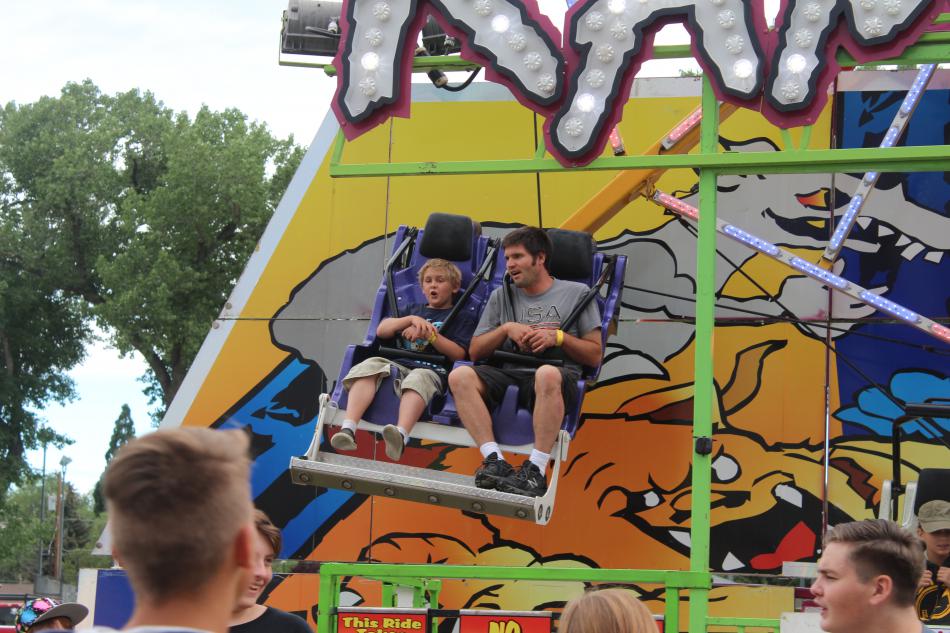 Crowds watch their family members sore high above the carnival.