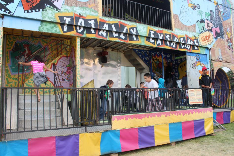 Kids run screaming through the carnival fun house.