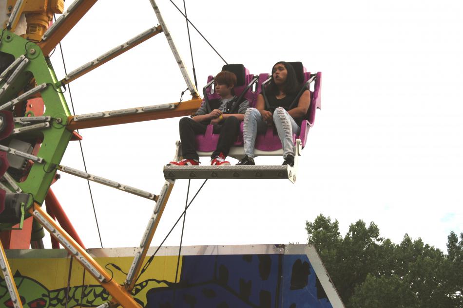 A couple watches the bussiling carnival below them.