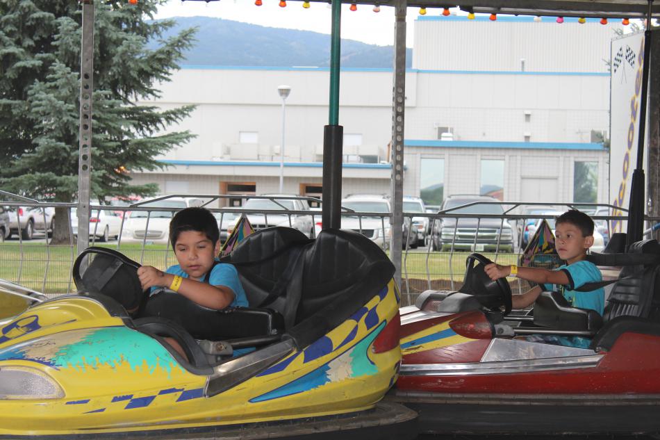 Brothers bash into eachother on their bumper cars.