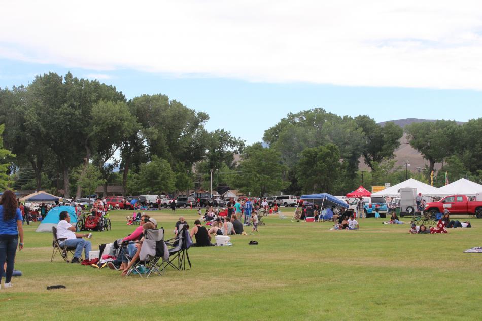 Families make camp to watch the fireworks on the Mills Park lawn.