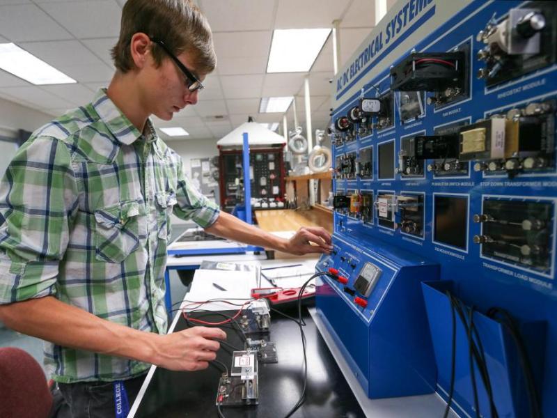 Western Nevada College student CJ Straw building and testing an electrical circuit in the Applied Industrial Technology program.