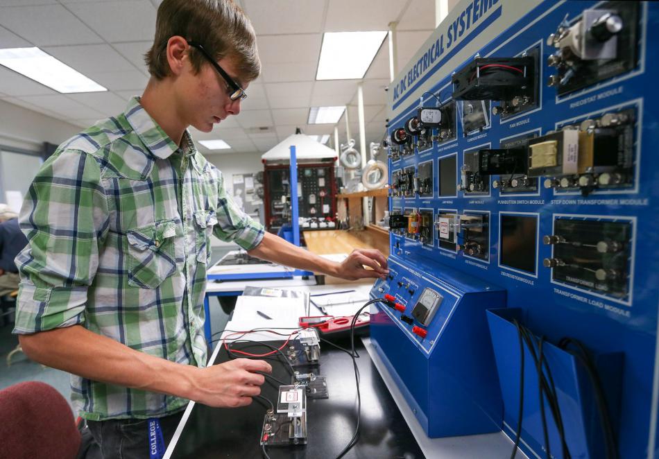 Western Nevada College student CJ Straw building and testing an electrical circuit in the Applied Industrial Technology program.