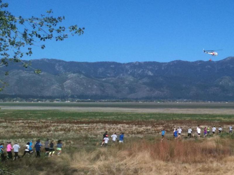A Nevada Division of Forestry helicopter drops water to signal the start of Washoe County’s Wildfire Awareness Run in May.