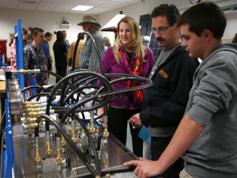 WNC Professor Emily Howarth, left, with Skip and Garret Nicholson in the Applied Industrial Technology laboratory.
