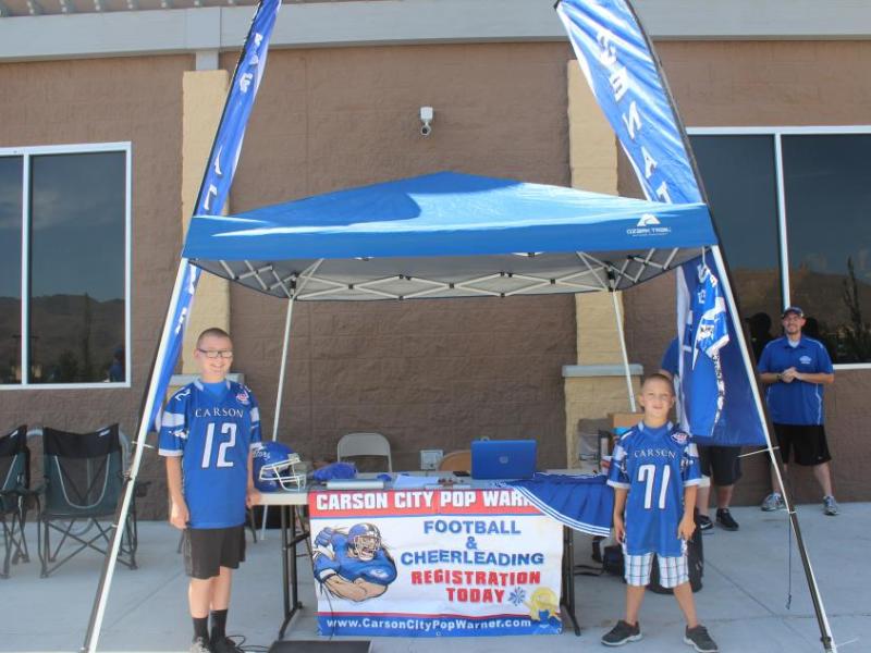 Vincent and Santino Feretti pose at the Pop Warner Football and Cheerleading registration booth
