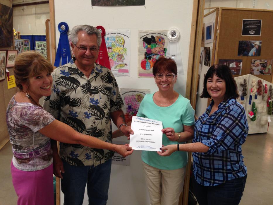 Howard and Linda Vernard of Gardnerville stand by their granddaughter Bristol's 3rd place entry for the coloring contest.