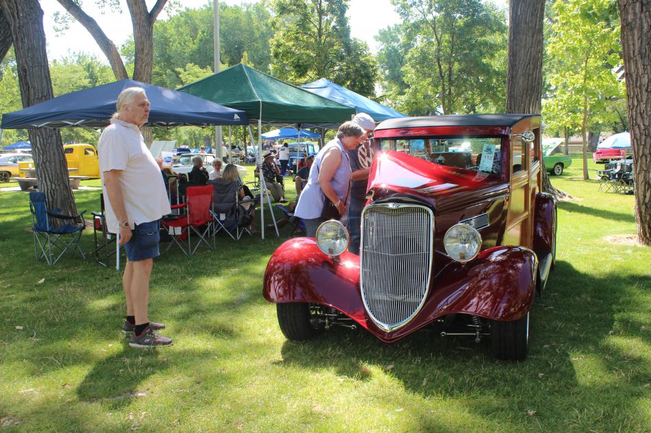 The inside of an old red car is polished to perfection
