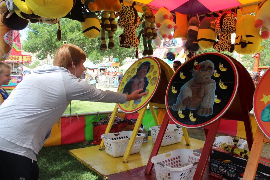 Boys try their might to win large stuffed animals