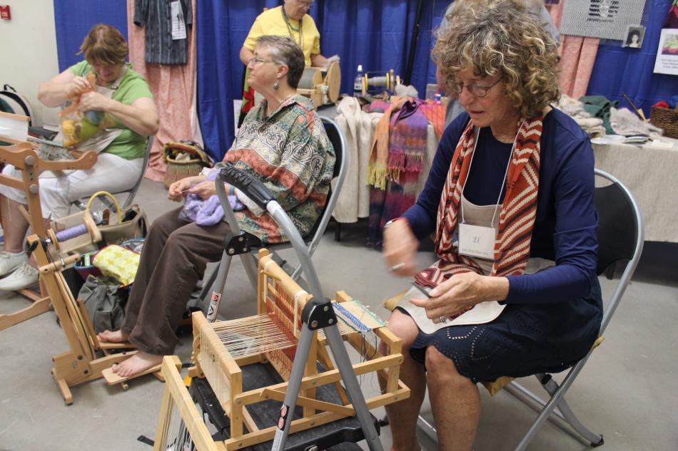 Ladies from Job's Peak Fiber Arts and Carson Sierra Spinners show guests how to weave and spin