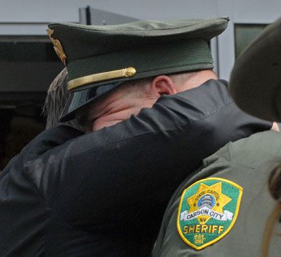 Carson City deputy Chris Rivera embraces Reno Airport Police officer Keith Bopko. Marilyn Newton, Nevada Photo Source