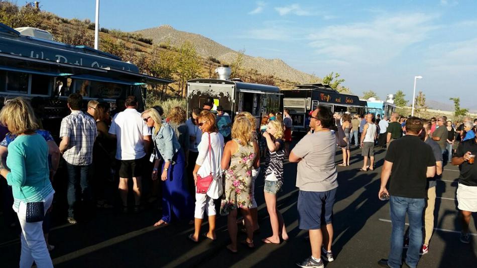 Attendees line up for tasty treats from local food trucks.