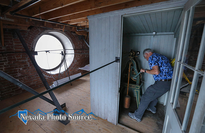 Bill Hartman winds the historic clock in the tower in the Laxalt Building in Carson City. Cathleen Allison, Nevada Photo Source
