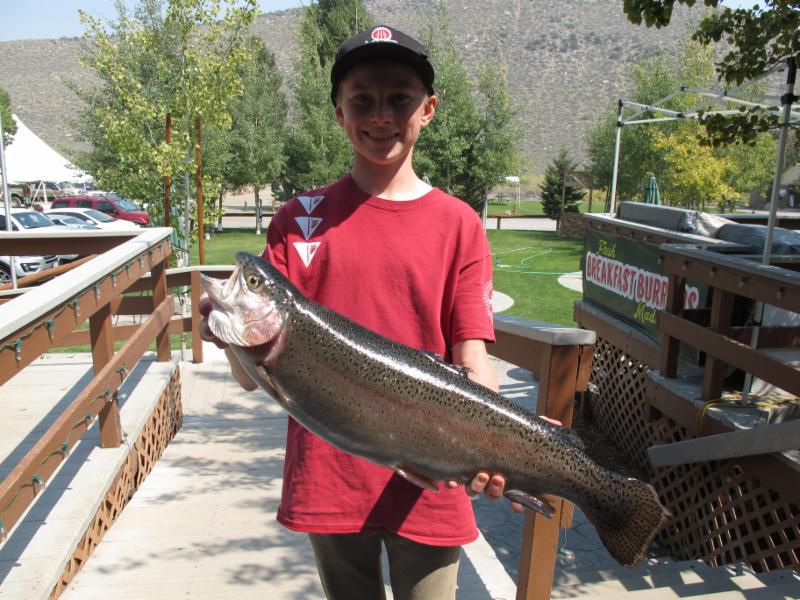 A happy youngster with his 7-pound, 8-ounce Rainbow Trout caught at Convict Lake, Calif.  Courtesy of the Convict Lake Resort