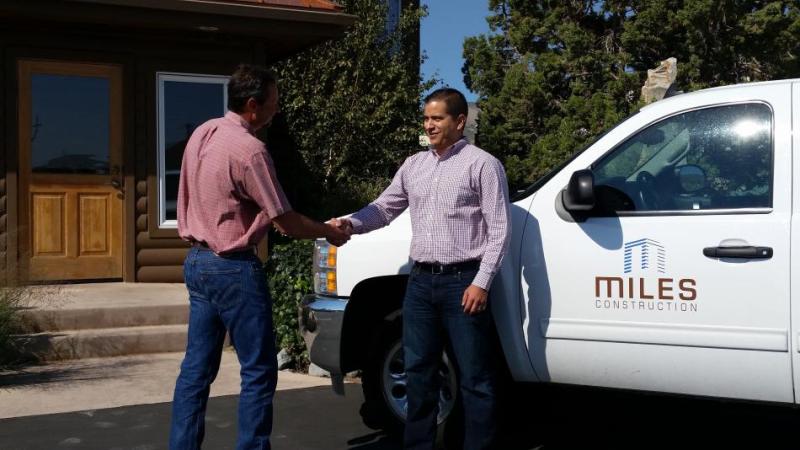 Cary Richardson, vice president of business operations at Miles Construction, congratulates Victor Mejorado on joining the firm.