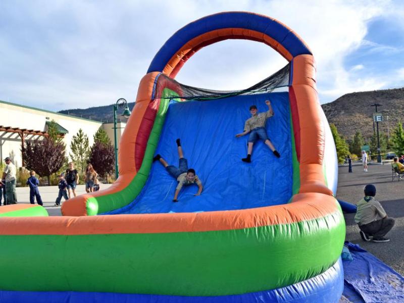 Scouts laugh out loud as they race down the slide.