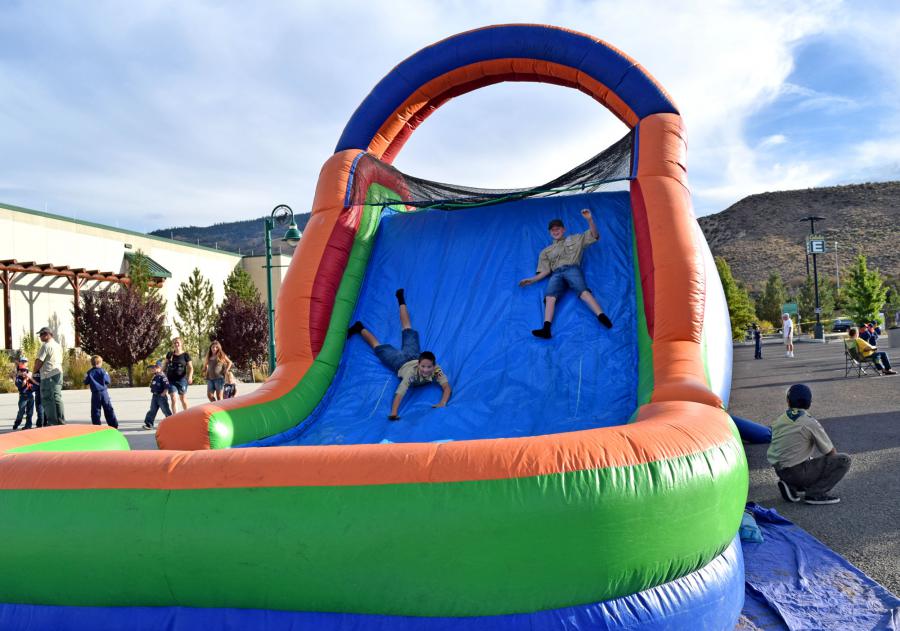 Scouts laugh out loud as they race down the slide.