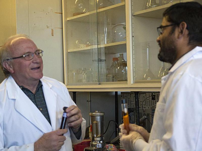 Glenn Miller and Bishnu Neupane holding the final biofuel product based on the gumweed plant.