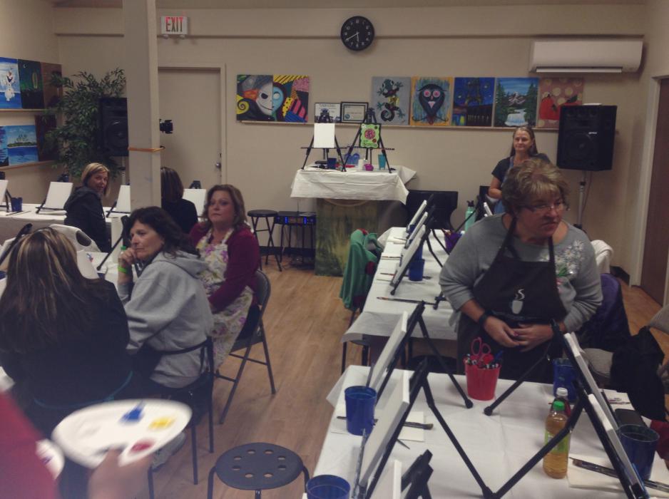 Would-be artists prepare for their painting lesson during the grand opening of Van Gogh and Vino last week.