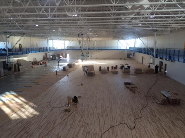 Crews put down the MAC's maple floor on Friday. Photo courtesy of Parks and Recreation Department.