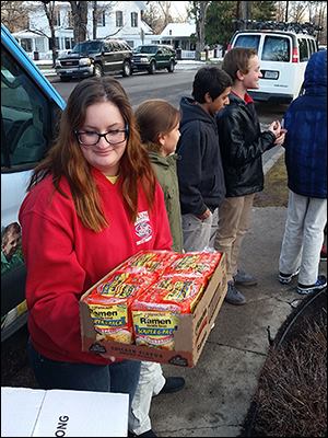 Kids Klub Volunteers help stack incoming donations.