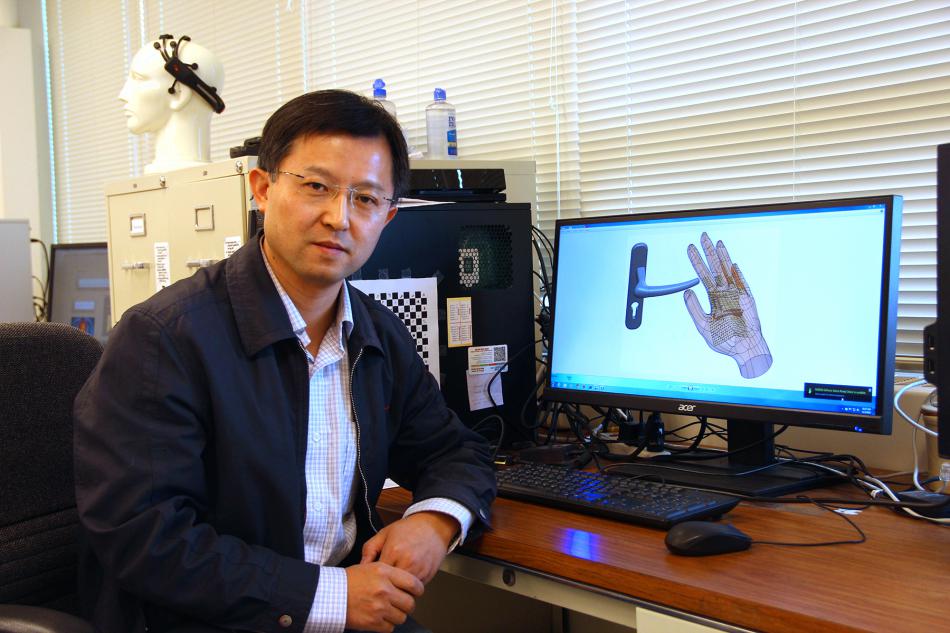 Yantao Shen, assistant professor at UNR, is developing a device to help the blind and visually impaired.