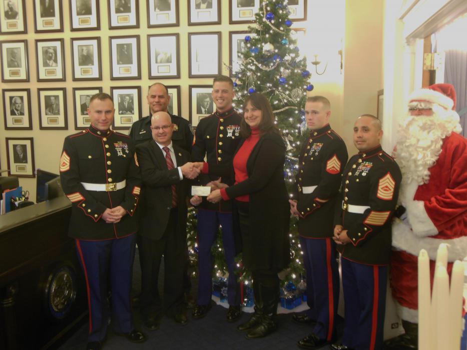 Joyce Buckingham (center right) accepts a check from Michael Giurlani of the Nevada State Law Enforcement Officers' Association